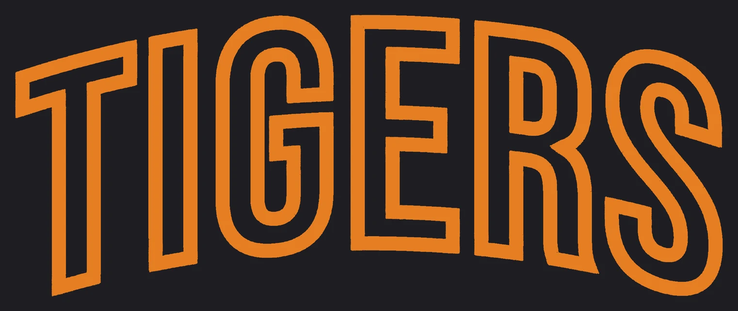 The word TIGERS in a straight-sided arch with a raised puff satin border